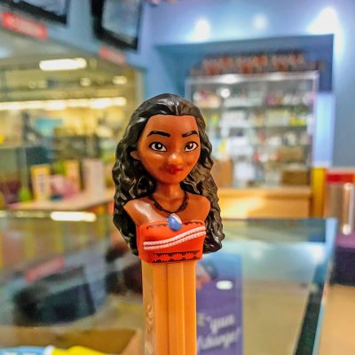 A candy dispenser stick has the head of a Hawaiian girl.