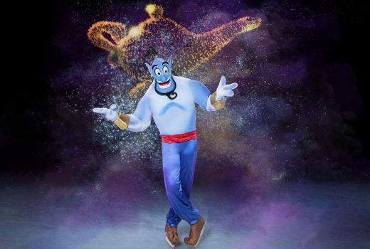 A blue genie, The Genie, poses with a shrug.