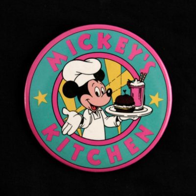 A circle with Mickey as a waiter-like chef.