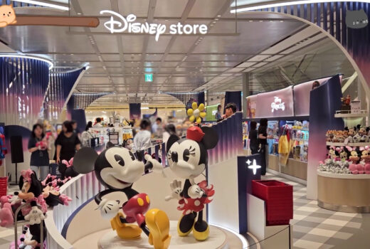 The front of a store, within a department store. Figures of Mickey and Minnie are shown.