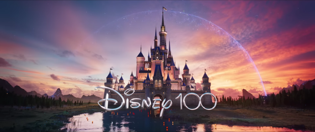 The words "Disney 100," with a fantasy castle in behind. It's on a large pond of water.