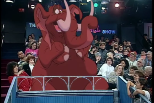A red elephant in the audience of a talk show.