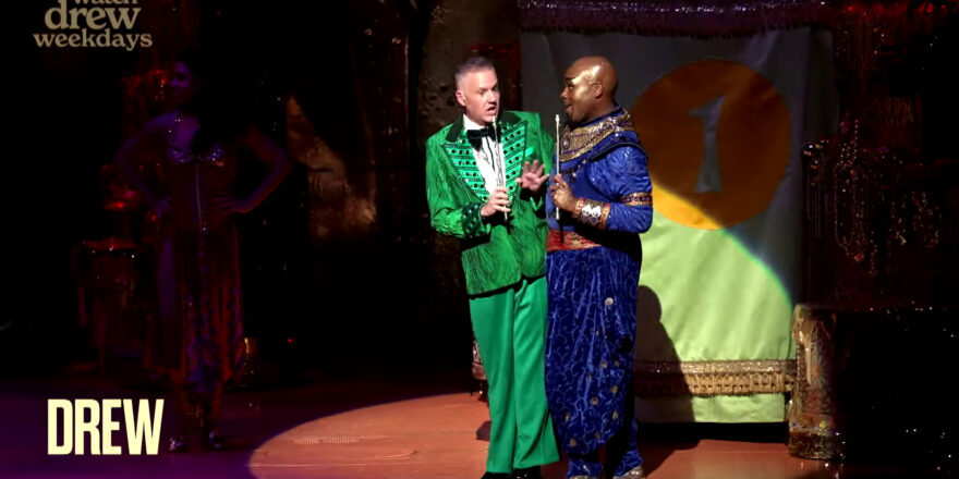 Two men in colourful suits, Ross Mathews and Michael James Scott.