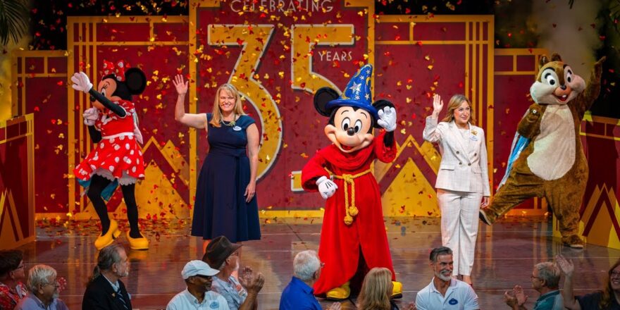 Mickey, Minnie, a chipmunk, and two humans on a stage.
