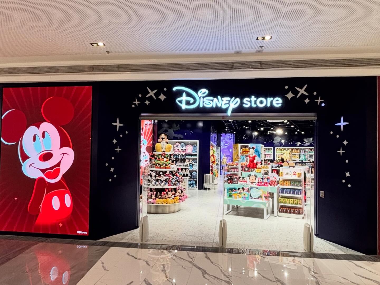 The frontage of a Disney Store, with a red screen showing Mickey Mouse.