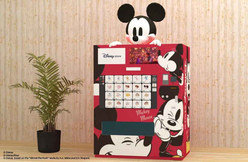 A red vending machine with Mickey multiple times on it, large, and a Mickey head above.