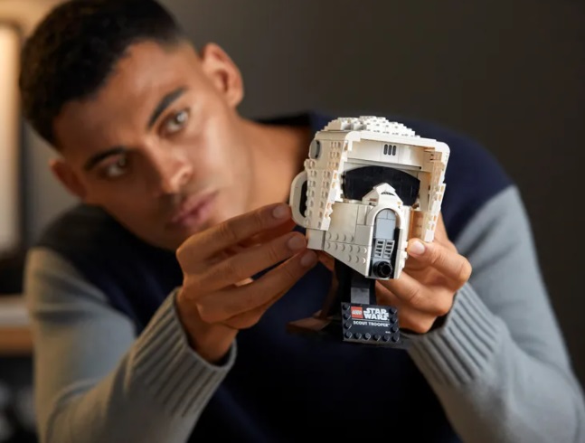 A man holds a LEGO helmet