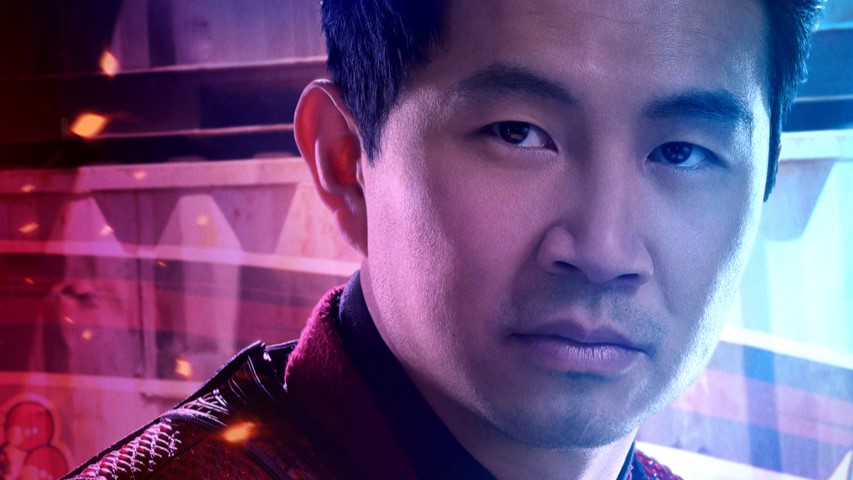 A man looks, concerned, on a three-quarter angle. He is lit in red and blue light.