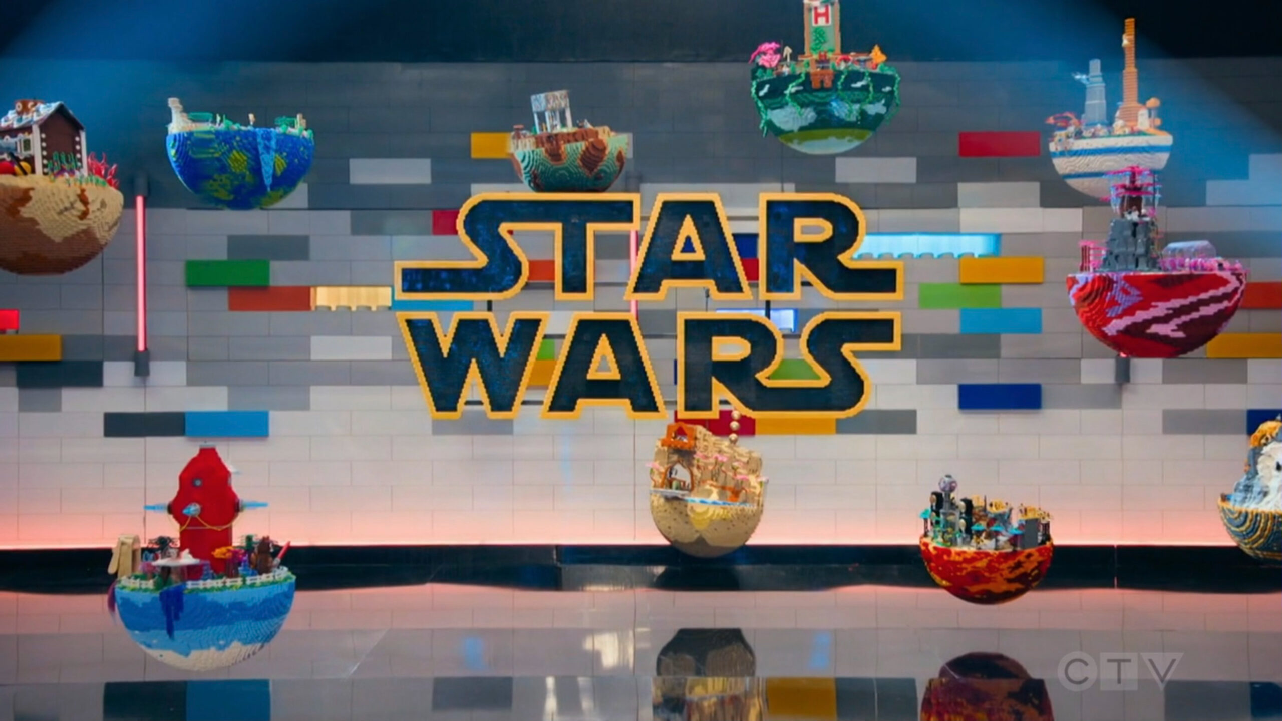 Planets made of LEGO hang around the STAR WARS logo.