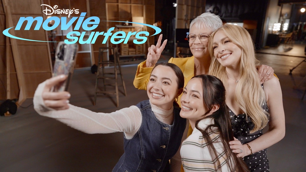 Two young women pose for a photo with two other women.