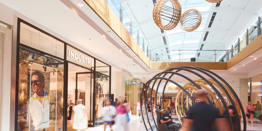 Interior of a mall with decorations that really don't scream Christmas, but are okay.