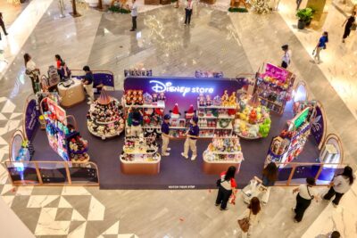 Overhead view, looking down at a series of Disney displays in the concourse of a mall.