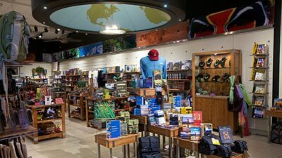 Interior of a store, thin but deep, a globe pattern on the ceiling.