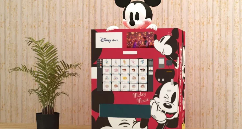 A red vending machine with Mickey multiple times on it, large, and a Mickey head above.