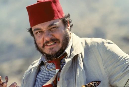 A man with a beard and a Middle Eastern hat.