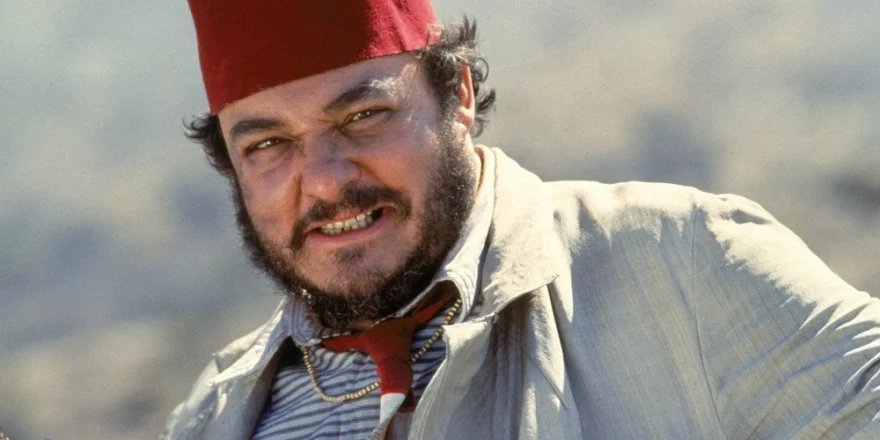 A man with a beard and a Middle Eastern hat.