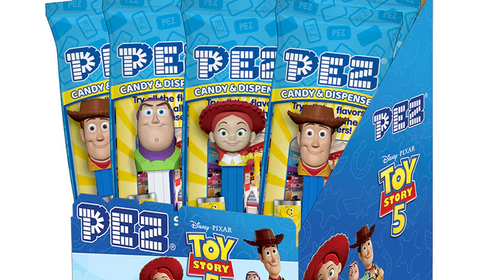 Small, tall bags hold candy dispensers with heads of cartoon characters.