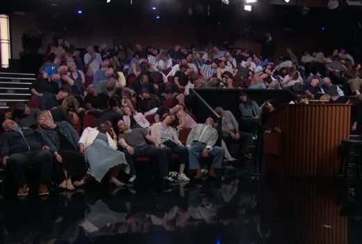 A crowd all flops over in their seats.