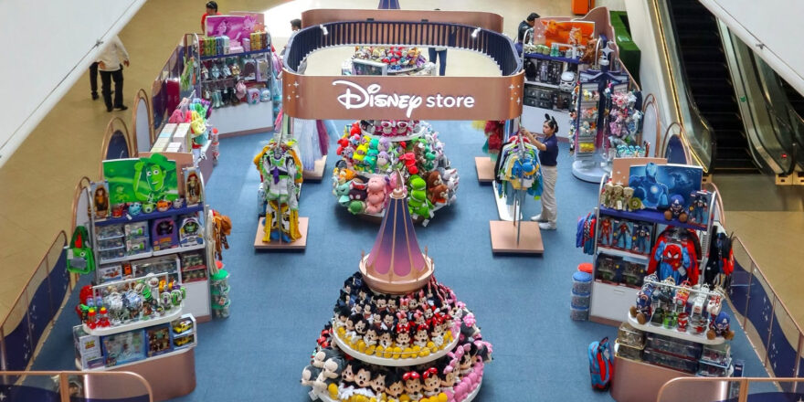 Overhead view of a display in the middle of a mall, including an arch labelled Disney Store.