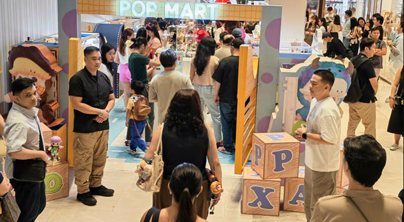 Raised view of a pop-up shop. The entrance has a blue and purple pattern referencing Sully.