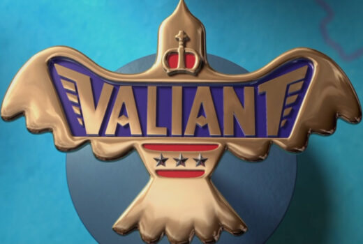 A metal pin-like item, reading Valiant. It shows a crown, wings, stars.