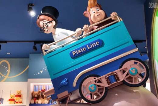 Statues of two boys in a small train car.