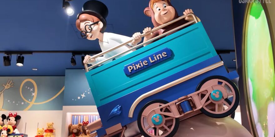 Statues of two boys in a small train car.