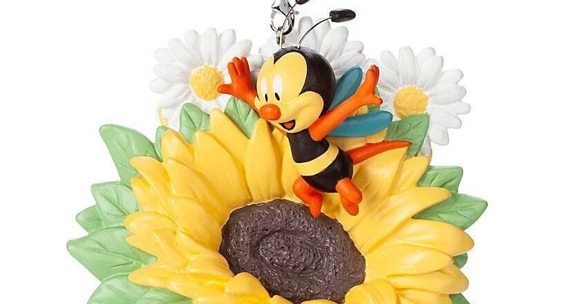An ornament of a bee and a sunflower.